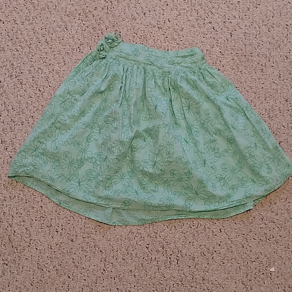 A girls green butterfly print skirt